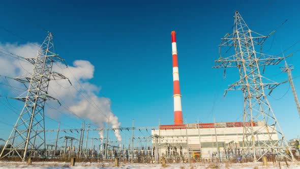 Large electrical substation and the smoke from the chimneys, time-lapse