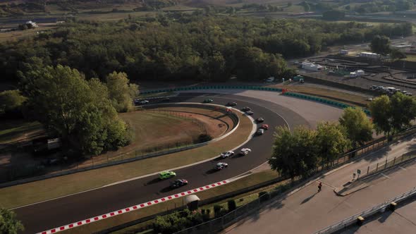 Aerial view of cars racing at Hungaroring race track during endurance competition, hairpin corner