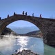 People crossing stone bridge on a winter sunny day - VideoHive Item for Sale