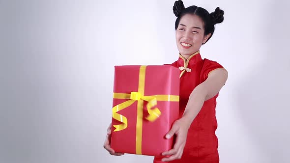 young woman holding red gift box in concept of happy chinese new year