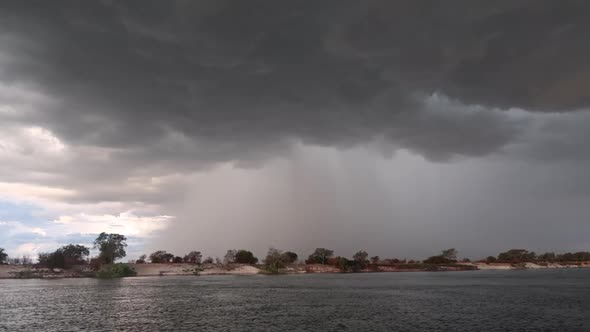 A summer storm approached brews with rain and wind in Southern Zambia as viewed from a small boat on