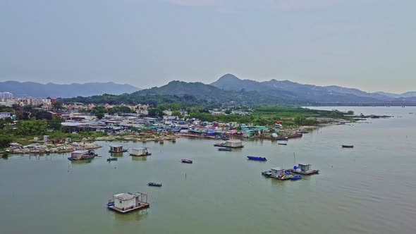 A dynamic onward aerial footage of the fishing village in Lau Fau Shan in the New Territories of Hon