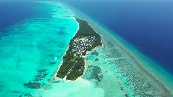 Natural above travel shot of a sandy white paradise beach and blue water background in hi res 4K