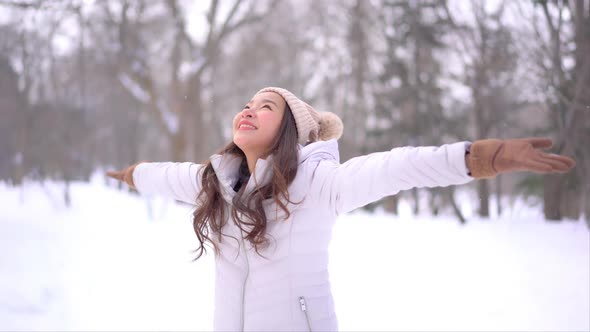 Young asian woman enjoy smile around snow and winter