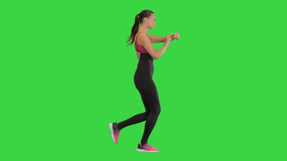 Healthy Sporty Young Woman Running and Using Smart Watch Device on a Green Screen Chroma Key