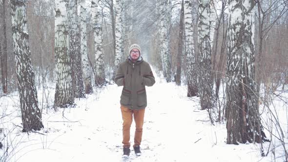 Man Walking in a Winter Forest