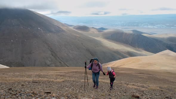 Mother with Little Daughter on Mountain Trek