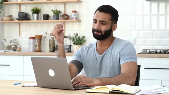 Tired Exhausted Indian Man Freelancer Designer IT Specialist Working Remotely at Home Overworked By