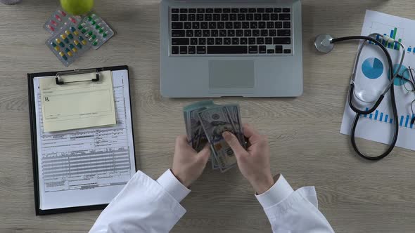 General Practitioner Counting Cash Earned on Treatment of Private Patient, Money