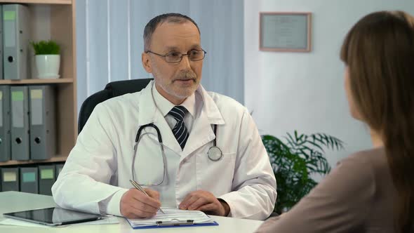 Woman Talking to Doctor, Physician Prescribing Medication to Patient in Clinic