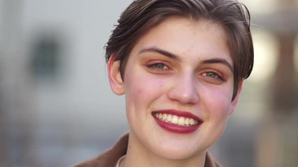 Close Portrait of a Lovely Young Girl with Short Hair and Red Lipstick