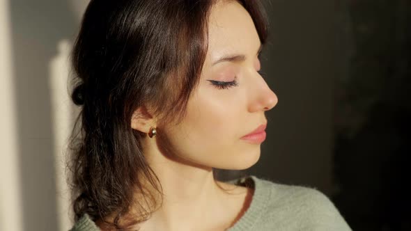 Portrait of a Beautiful Young Woman Sitting on Chair Enjoying Sunrise