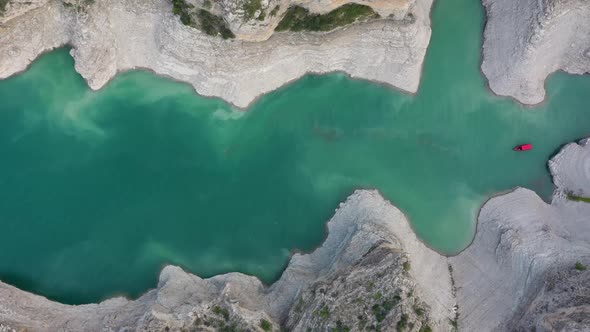 Top view of a mountain river in the canyon and  boat sailing along a turquoise river among the rocks