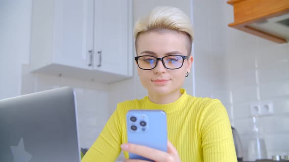 Yound adult white female using new smart phone for communication online during lockdown in 4k video