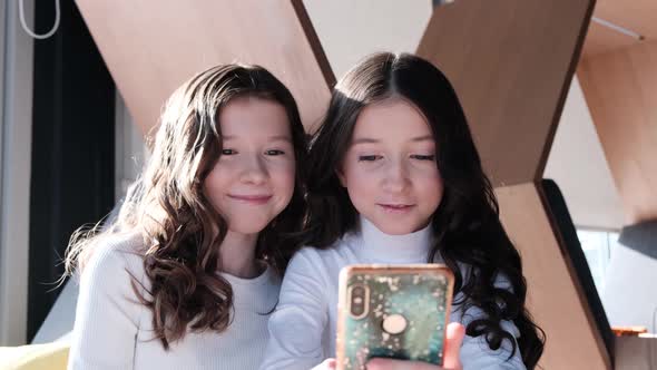 Two fun beautiful sisters take selfie photos