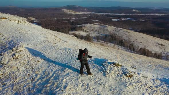 A Lonely Traveler Walks Along the Top of a Mountain Range