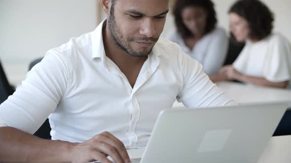 Concentrated Handsome Programmer Working with Laptop