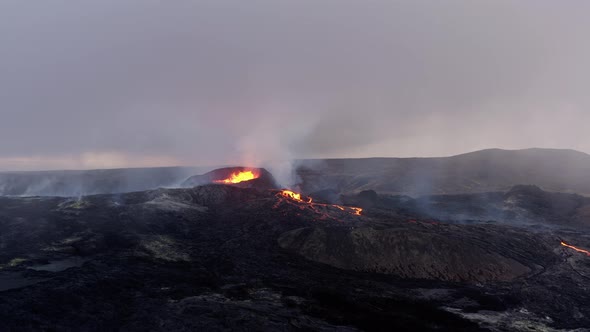 Distant View Of The Boiling Lava Lake With A Discharge Of Volcanic Steam From The Caldera.