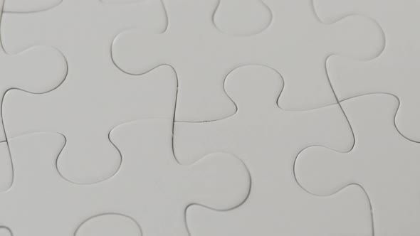 Hand Places One Piece of Puzzle on The Missing Part