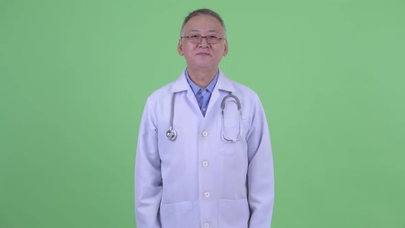 Happy Mature Japanese Man Doctor Bowing