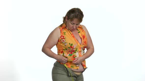 Overweight Woman Measuring Her Waist with Tape Measure