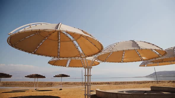 Lots of umbrellas for protection against sun is on the hotel's beach near the Dead Sea