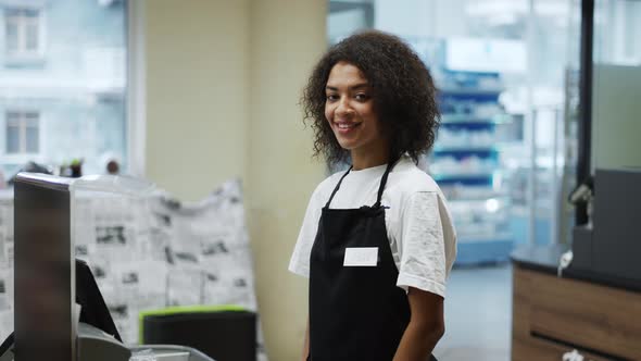 Portrait of an African American Worker at Grocery Store Checkout Friendly Smiling to Camera