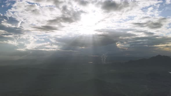 The sunlight shines through the dramatic dark clouds. the warm afternoon sky of the sun