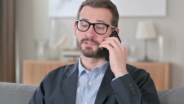 Portrait of Smiling Young Businessman Talking on Smartphone