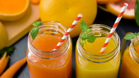 Close Up of Fresh Juices in Mason Jar Glasses 
