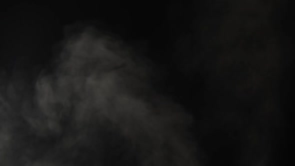 Steam or smoke over black background