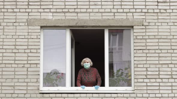 Old Woman Grandmother Stay at Window Isolated at Home on Quarantine. Coronavirus