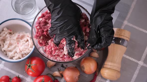 Kneading of Minced Meat with Onion and Spices in a Glass Bowl