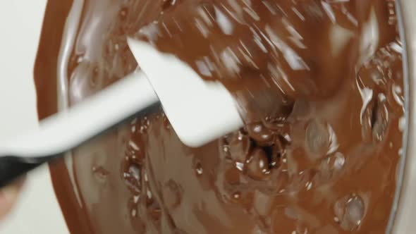 Vertical Shot Closeup Stirring Mixing Dark Melting Chocolate in Glass Bowl Slow Motion