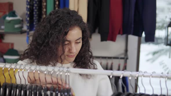 Female Choosing New Dress in a Store