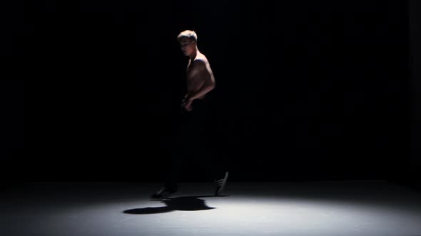 Breakdance Blonde Dancer with Naked Torso Starts Dance, on Black, Shadow