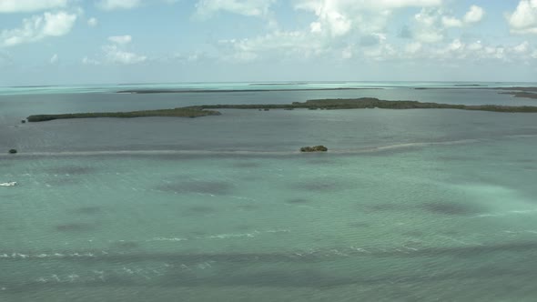 Aerial video heading towards a small group of islands off the coast of the florida keys