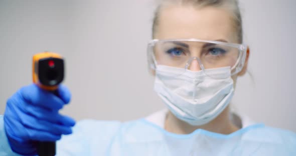 Doctor Measuring Patient Temperature at Health Care Clinic