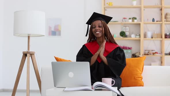 Graduate Woman Wear Cap and Gown and Have Online Distant Family Meeting Spbi