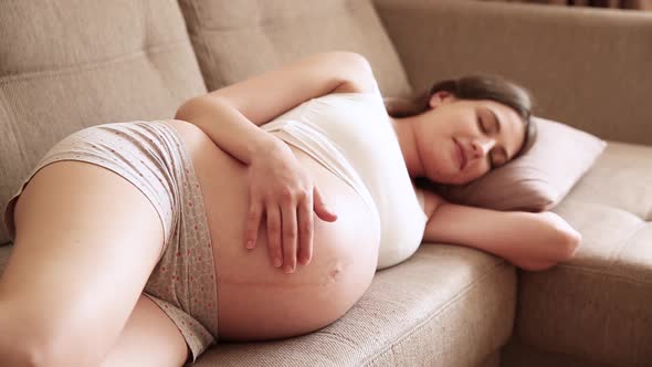 On a Sunny Summer Day a Happy Expectant Mother Strokes Her Bare Belly and Rejoices