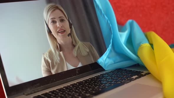 Laptop with Video Conference and Presentation Near the Flag of Ukraine