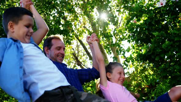 Father playing with his kids in park