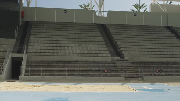 Side view of mixed race athlete doing long jump