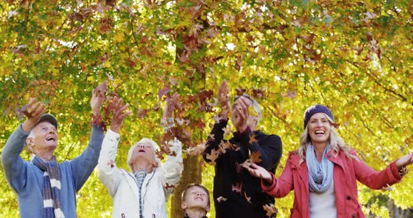 family throwing leaves outdoors