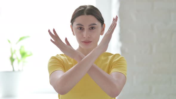 Portrait of Woman Showing No Sign by Arms Crossed