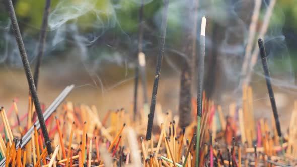 Closeup Dolly Video of Burning Incense Sticks in Buddhist or Hindu Temple