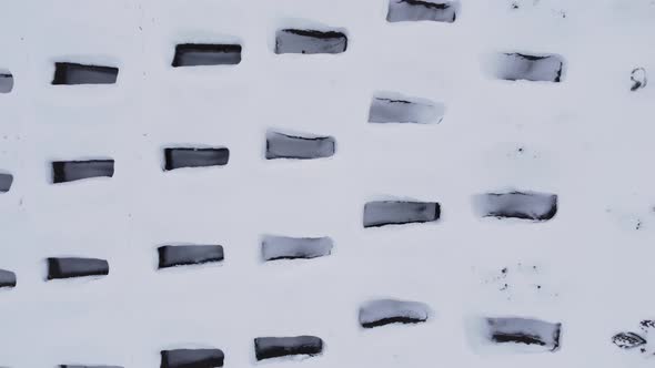 Open Empty Graves Among the Snowy Field Aerial Drone View of Emty Tombs in the Winter