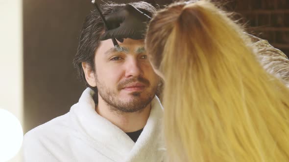 Young Stylish Man in a Beauty Salon. Face and Eyebrow Care