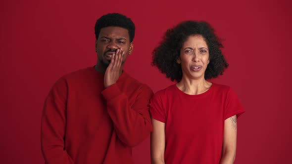 Displeased African couple looking at the camera