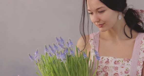 Woman Holding Bouquet of Flowers in Hands Indoors